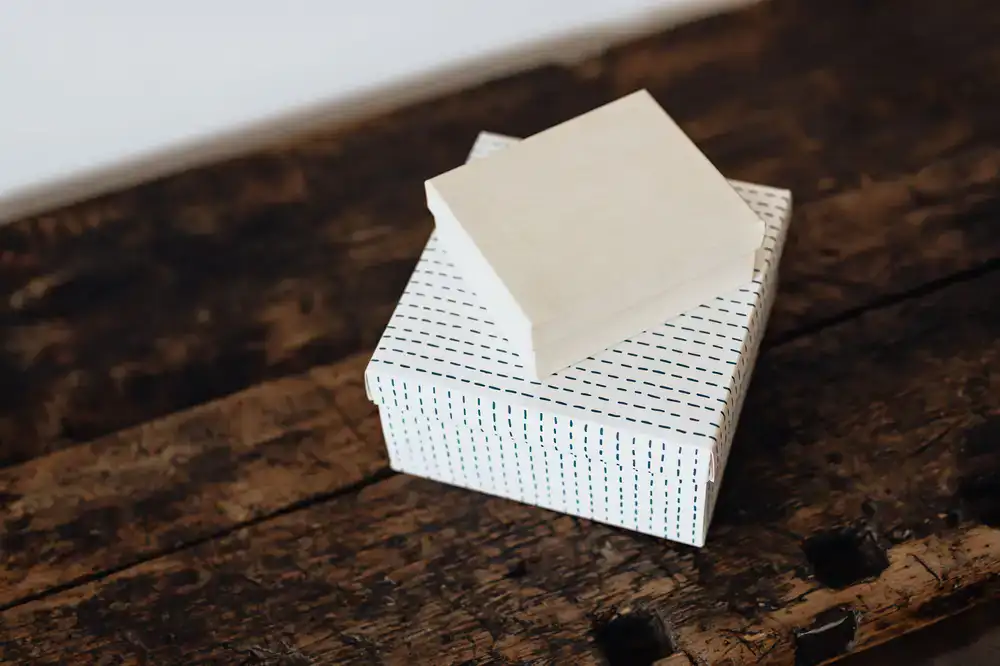 Elegant gift box of custom-blended tea sitting on a minimal wooden table