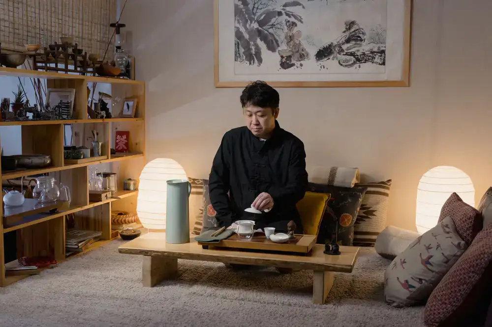 A serene seating area featuring a low wooden table and minimalist teaware