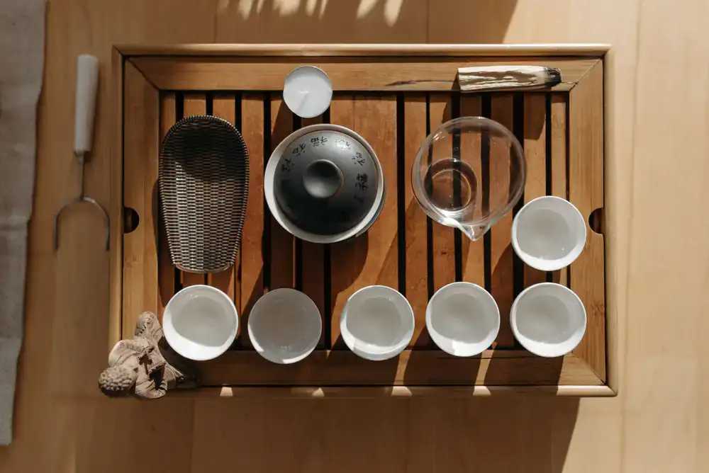 Overhead view of a serene tea ceremony setup with ceramic bowls and a bamboo scoop